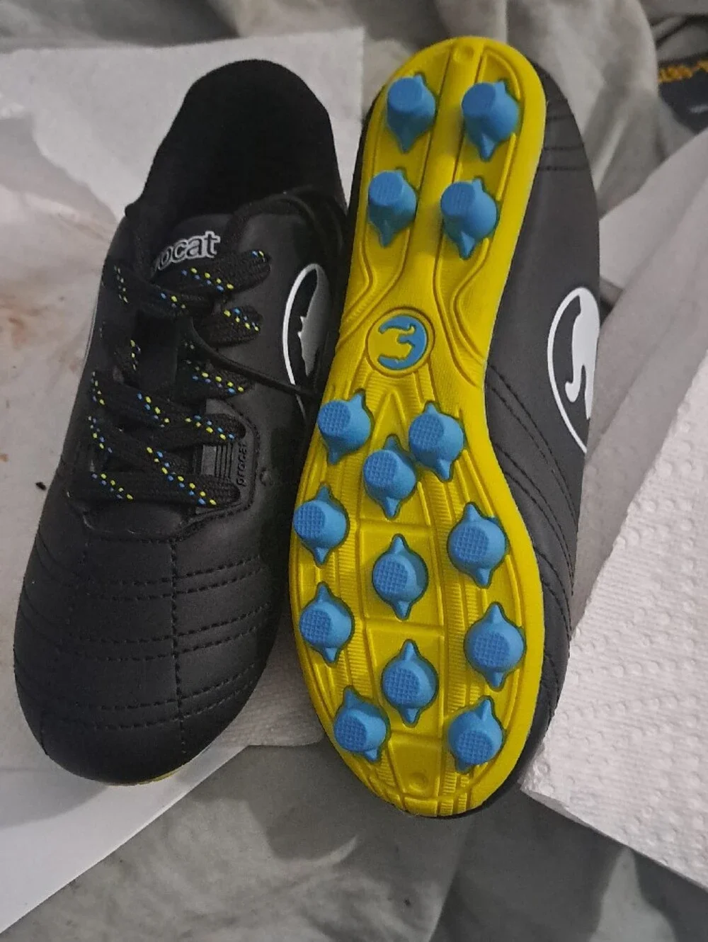 Puma Kids Black Soccer Cleats with Yellow Sole and Blue Studs